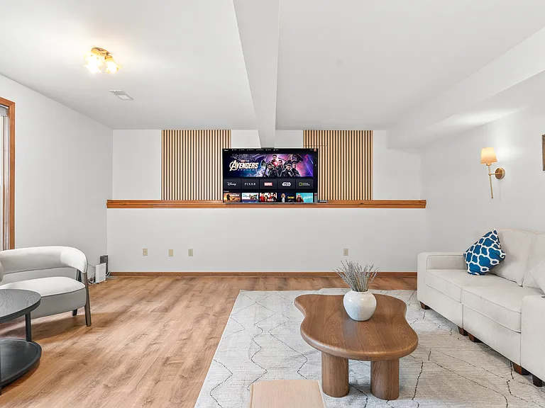 Spacious basement recreation lounge with generous seating and plenty of open space for relaxing, entertaining, or gathering with family and friends.