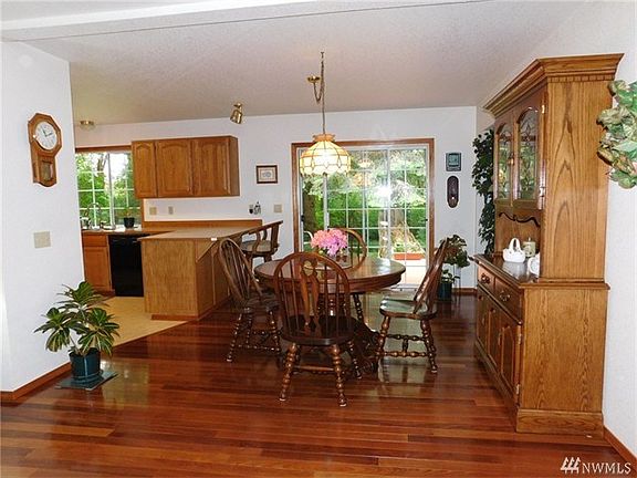 Eating area off kitchen with slider to back deck.  Brazilian hardwood flooring that is just beautiful.  Custom wood wrapped windows finishes this home off.