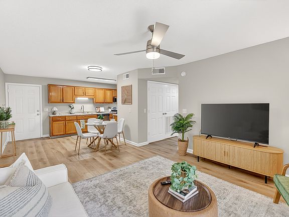 Open-concept living room with dining space at Saddlebrook Apartments