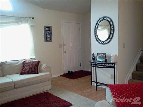 Wood floors in entry and walkway including the kitchen and eating area.