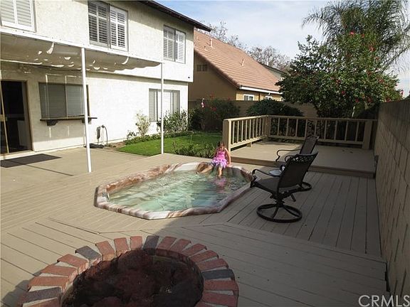 Backyard with wood deck, covered patio, and spa.  A perfect yard for entertaining.