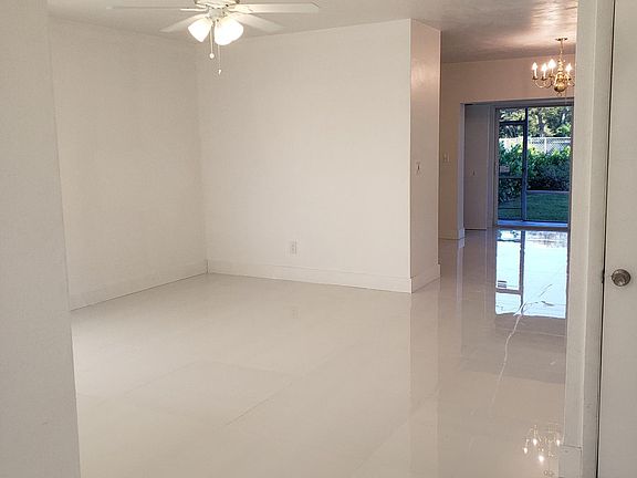 Entrance showing living room, flowing through to kitchen, dining room and sliding glass doors out to private garden.