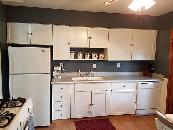 Kitchen with newer white appliances included