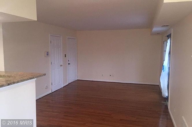Front door and part of living room shown unfurnished