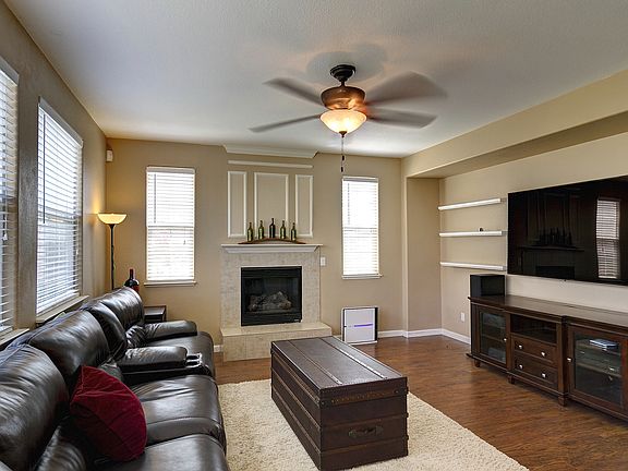 Living Room with Ceiling Fan and Fireplace