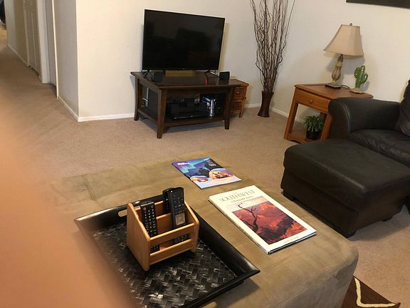 Living room, ottoman and entertainment center.