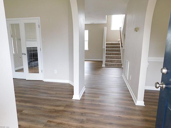 Foyer. Living Room to the left, Dining Room is on the right, the Family Room/Den is to the upper left.