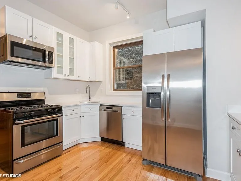 Open kitchen with quartz countertops and brand new stainless steel appliances