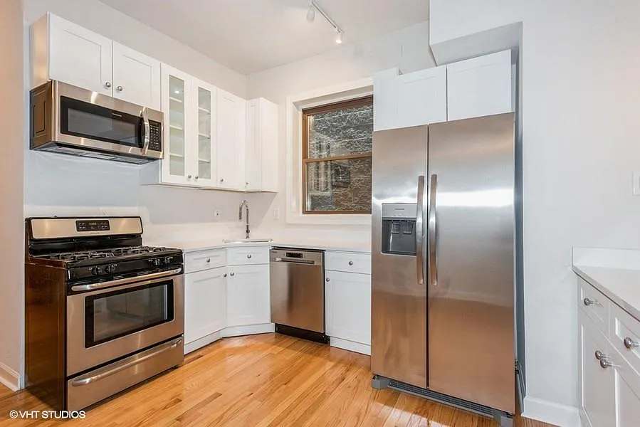 Open kitchen with quartz countertops and brand new stainless steel appliances