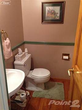 Half bathroom features pedestal sink and hardwood flooring
