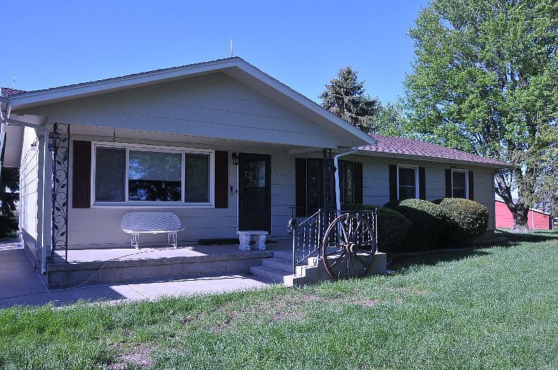 House from front : Nice porch, new bay window, yard and mature landscaping maintained well.