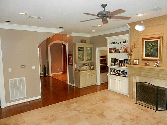 Living Room with Butlers pantry encompass the quality hardwood & travertine floors.