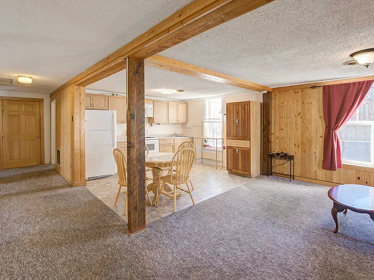 Step inside the front door and your carpeted living area. The dining/kitchen area has easy-care vinyl flooring. There's a top-freezer refrigerator and oven/range plus a microwave, too.
