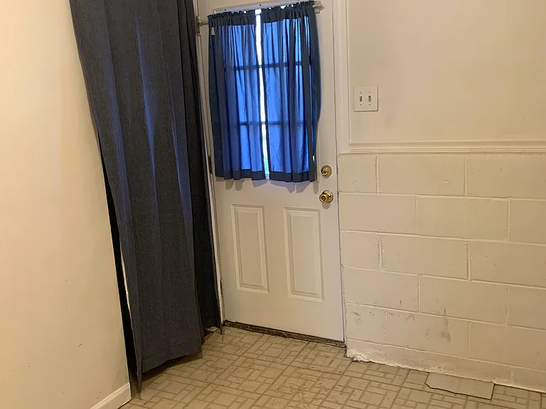 down rear hallway, back door and one of several bike storage areas
