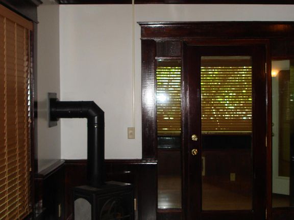 Living Room with Natural Woodwork and Natural Gas Fireplace/Parlor Stove
