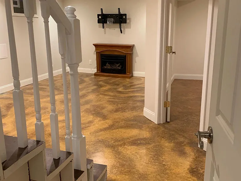 Family room in basement with gas fireplace and wall mount for TV