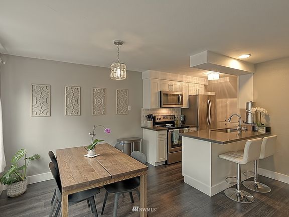 Modern Upgraded Kitchen with Quartz Counters, SS Appliances, Eating Counter and Dining Space. 