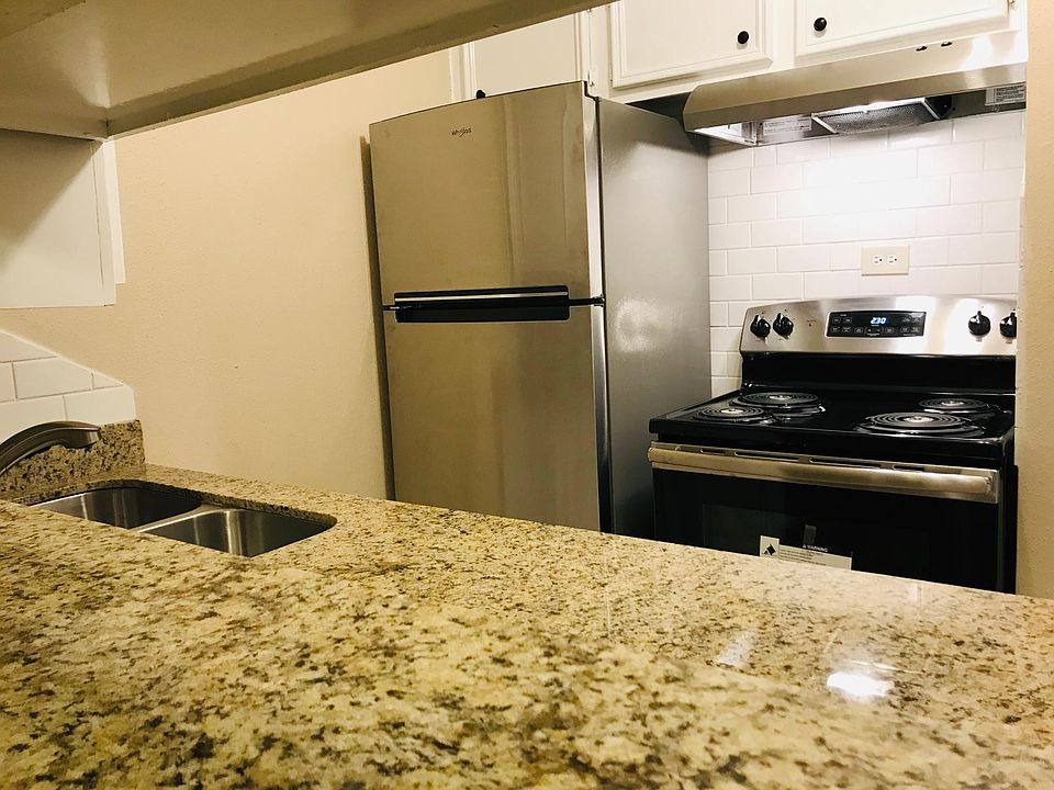 Gourmet kitchen fully equipped with stainless steel appliances.