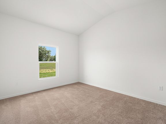 Master bedroom with a window facing the backyard