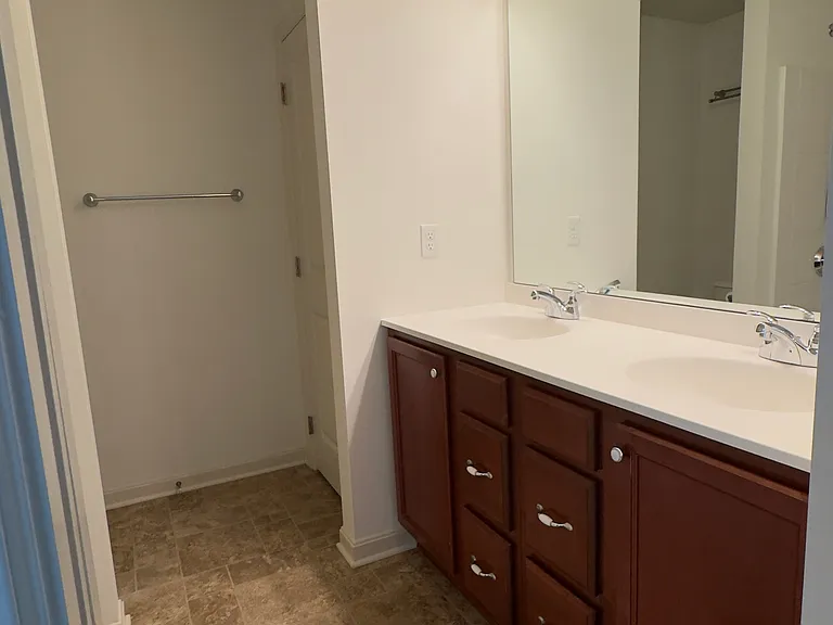 Primary bathroom with double vanity, and full sized bath/shower combo.