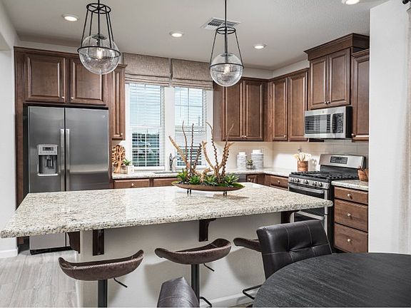 With a sizable center island, granite countertops and Moen R fixtures, this kitchen is as functiona