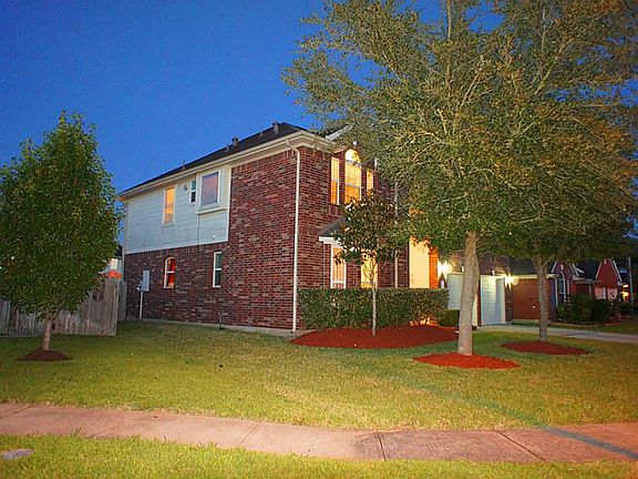 Attractive professional landscaping creates a dramatic approach to this inspiring single family