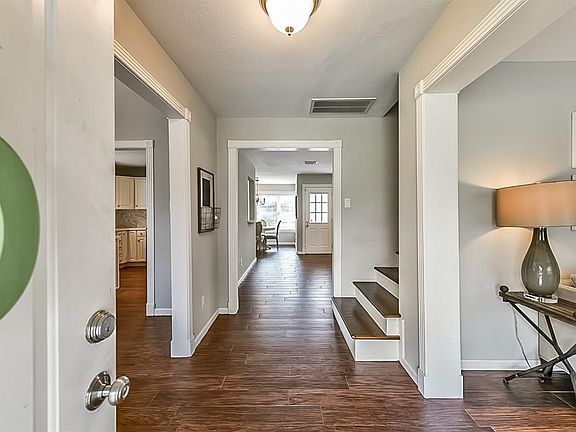 Stunning, bright entryway welcomes you into this updated 5 bedroom family home. This view showcases the updated flooring and painted walls seen through out the home.