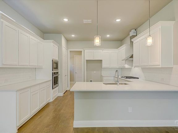 Kitchen in the Merlot home plan by Trophy Signature Homes - REPRESENTATIVE PHOTO
