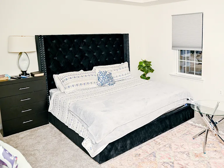 large primary with king bed and full bathroom