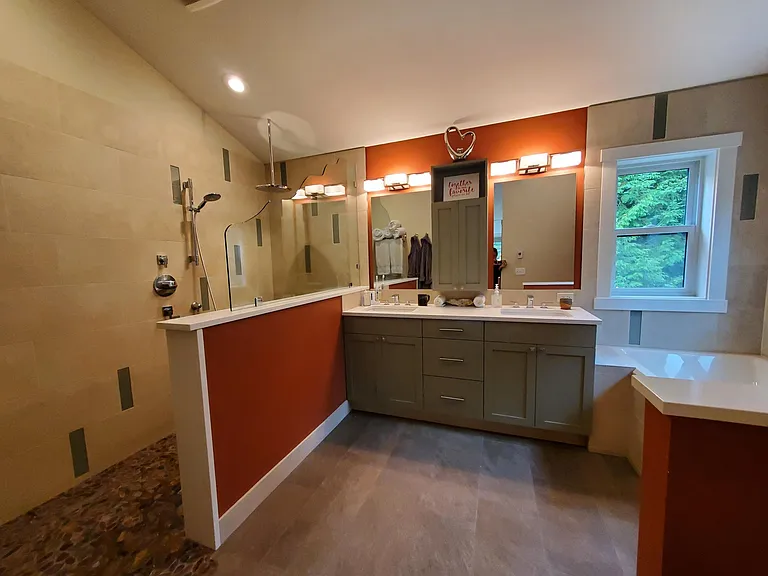 Primary bathroom has heated tile floors throughout, walk-in shower with rain head and personal shower, double vanity and a whirlpool soaking tub.