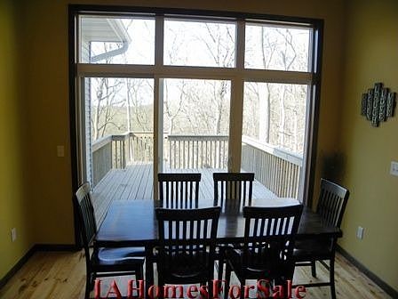 Dining Area with slider to the deck with wooded view