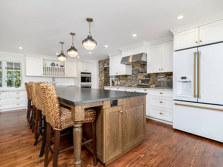 Original stone peeking through cabinetry