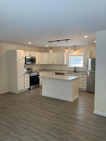 Very large open bright kitchen, dining and living room.