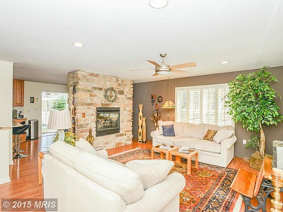 Living Room with two sided gas stone fireplace
