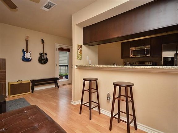 The living room also flows into the dining room & out onto the balcony.