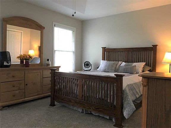 Master bedroom with a master bath and newer carpet.