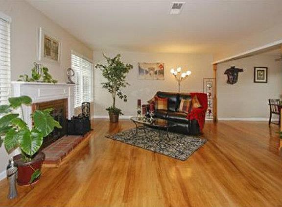 Living Room with Hardwwood Floors and Wood Burning Fireplace
