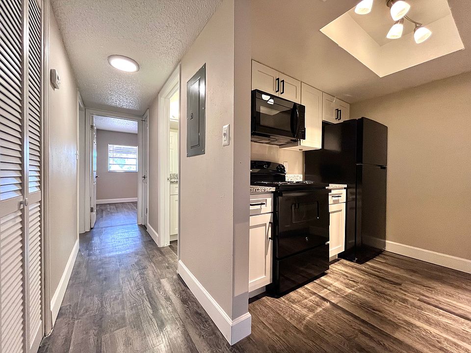 Step into contemporary living with this stylish apartment featuring a sleek hallway and a fully-equipped kitchen.
