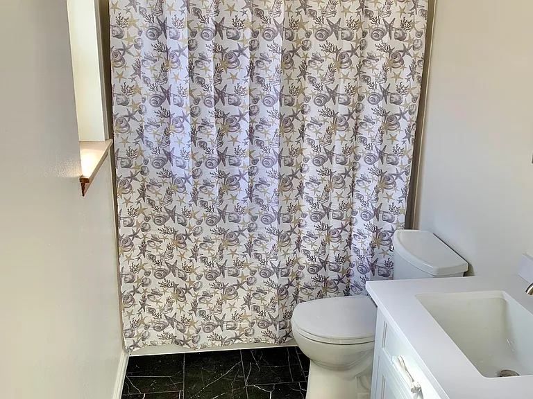 Completely updated master bathroom with new tile flooring, toilet and upgraded vanity and fixtures
