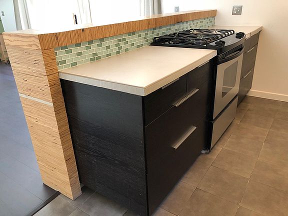 Kitchen and custom plywood bar.