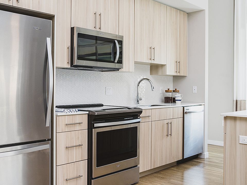 Wood plank-style flooring with expansive windows and natural light
