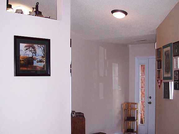 Foyer with vaulted ceiling and hardwoods.