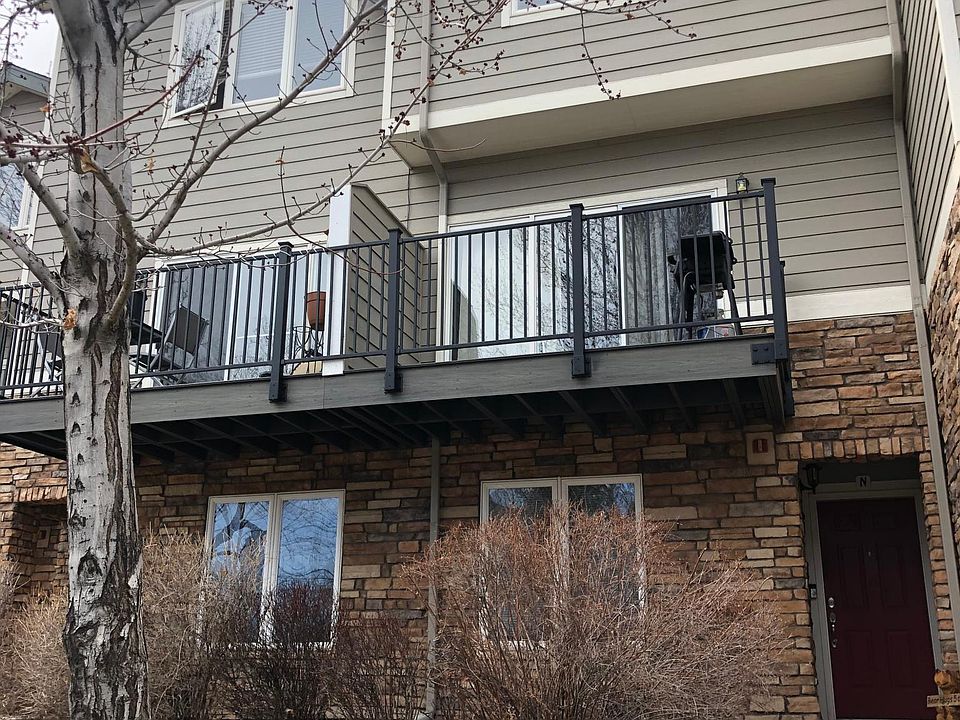 Front outside view showing brand new trex deck with metal railing. Established large tree in the front yard area.