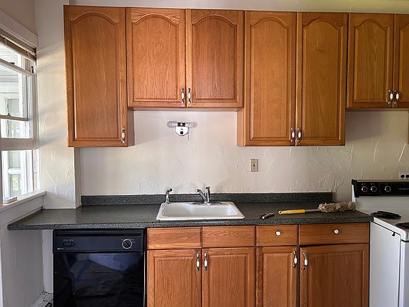 Kitchen 15 x 8 with quality oak cabinets and luxury vinyl plank flooring