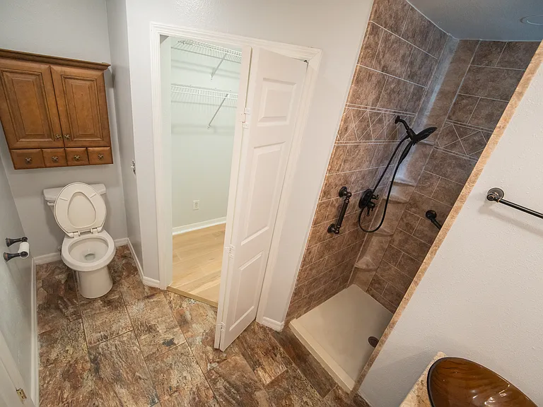 Storage behind the toilet.