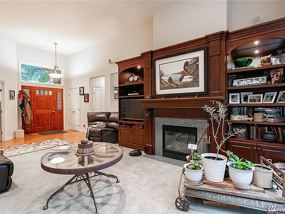 Living Room looking at Fireplace and Entry. The built-in Wall Unit surrounding Fireplace is included in sale!