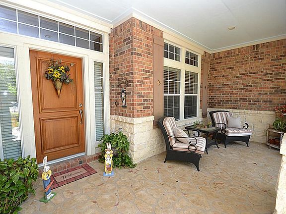 Front porch and doorway with stone accents inviting you inside.
