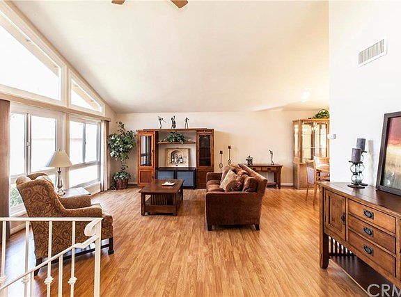 Enter into a living room with cathedral ceilings, floor to ceiling windows that allow this home to fill with light!