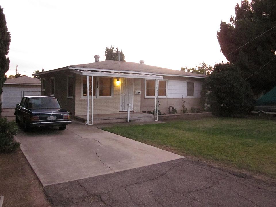 Front of house showing driveway, front yard, porch, gate and garage in back
