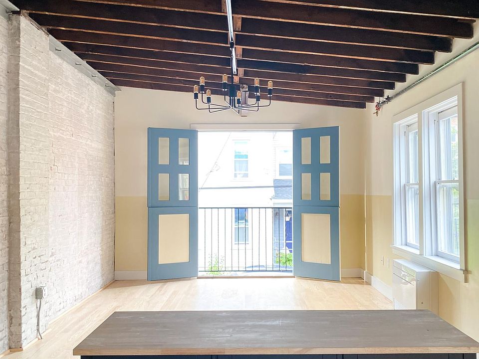 Living with exposed brick and hayloft doors (open)